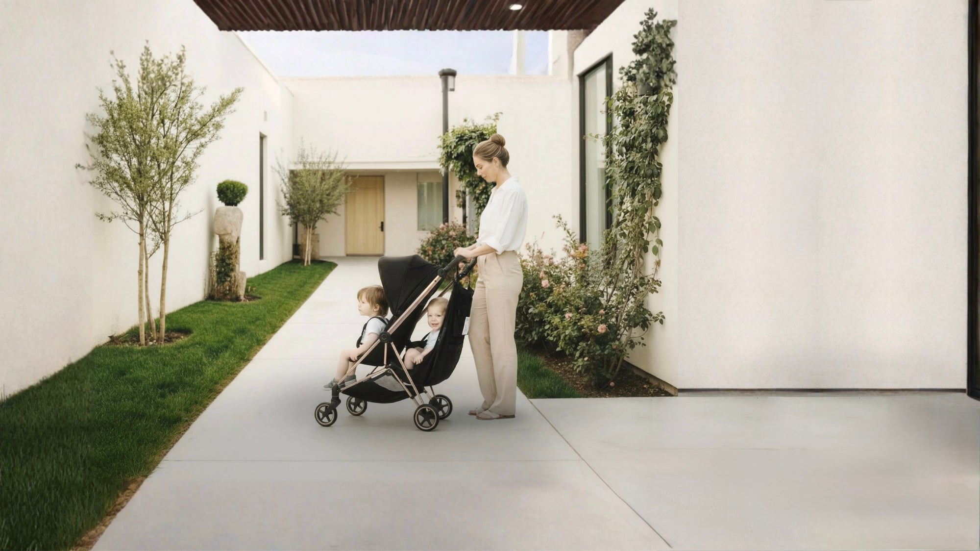 Woman pushing a stroller with a child in the stroller sling hammock in a modern outdoor setting