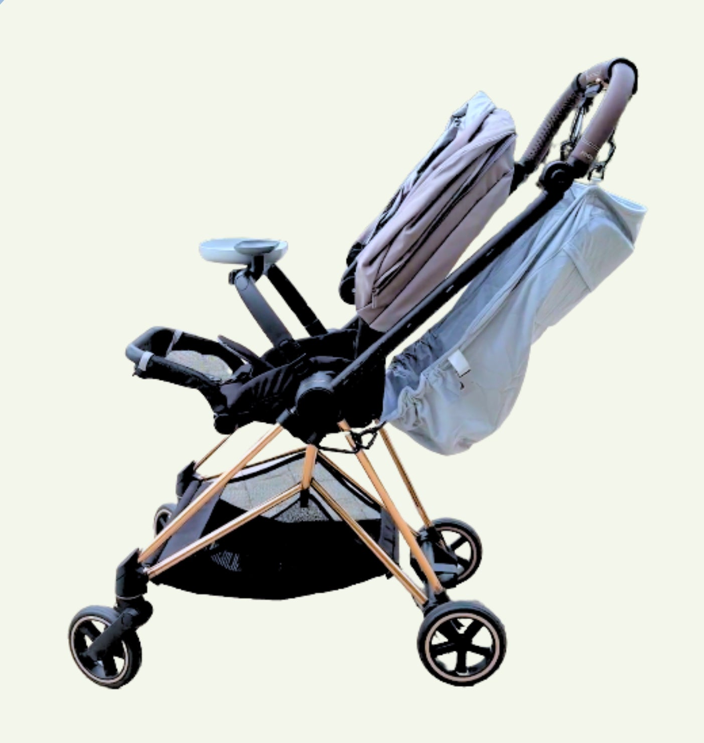 The Stroller Sling toddler hammock securely attached to a single stroller, transforming it into a tandem setup for two children.